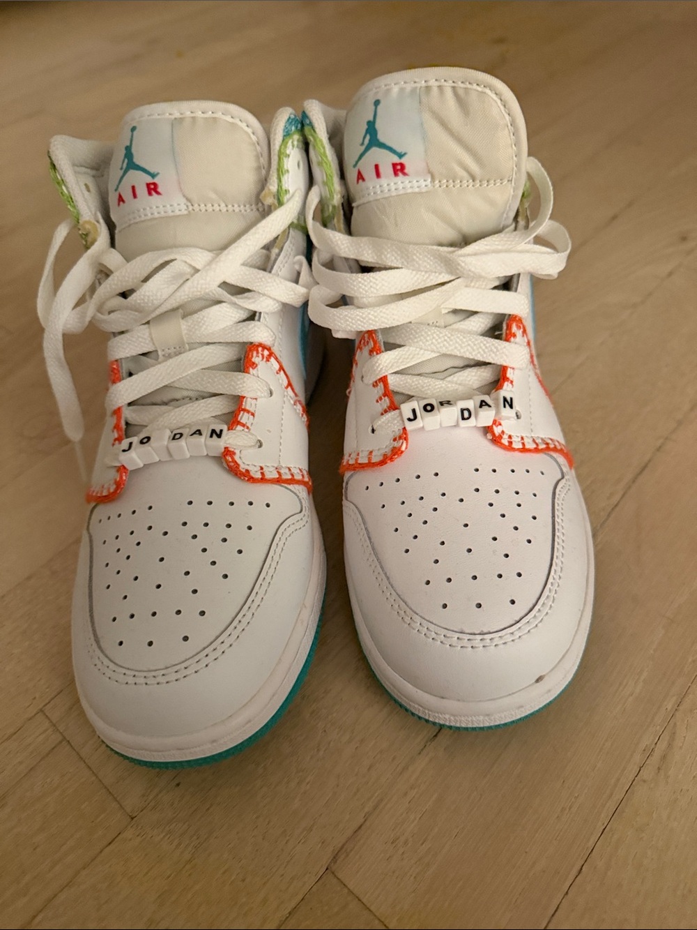 Nike Kids' White Sneakers with Teal and Orange Accents